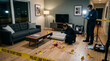© Remon - Crime Scene Investigation Detectives examine evidence of a violent crime in a modern living room marked by yellow tape