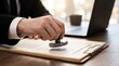 © Studio KN - commercial loan approval and certification process. business professional stamping certified approved seal on loan agreement. legal document verification with clipboard and laptop in office.