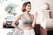 © halayalex - Young beautiful smiling hipster woman in trendy summer jeans and top clothes. Sexy carefree model posing on the street background at sunset. Positive brunette female. Cheerful and happy