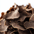 © Vasyl Onyskiv - Black truffle shaving macro isolated on white background with clipping path, presenting concept of luxury gourmet food and cuisine