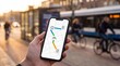 © Gayan - Hand Holding Smartphone With Multimodal Route Map Concept