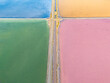 © Amazing Aerial - Aerial view of colorful salt evaporation ponds at Bedwell Bayfront Park, with vibrant blue, green, yellow, and pink water separated by narrow paths in Menlo Park, California, United States.