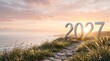 © IMAGE STORE - 3d render of the year 2027 standing on a scenic grassy cliff path overlooking the ocean at sunset, symbolizing a new beginning and future goals