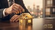 © Oliur - A businessman carefully constructs a delicate tower of golden bars symbolizing wealth investment and the risks of financial growth in a modern