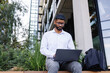 © Angel Santana/Stocksy - Young businessman working remotely on laptop in city