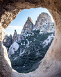 © Aliye - Uchisar castle view through cave rock window in Cappadocia Turkey