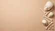 © Protim - Minimalist Halloween background featuring human skulls, long bones, and vertebrae arranged along the right side against a solid beige surface with ample negative space