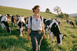 © Pakpong - Woman, cow, pasture, farm, rural lifestyle with calm female walking in field