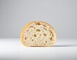 © Tang - Close-up of a single slice of bread on a plain surface with a neutral background