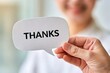 © whitestorm - Person holding thanks speech bubble sign for gratitude and appreciation
