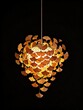 © wilson - Modern artistic hanging pendant chandelier light decorated with clustered golden ginkgo leaves glowing warm light on black background natural inspired luxury home decor concept