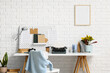 © Pixel-Shot - Creative writing and freelance work, vintage typewriter on desk with home office decor and blank picture frame on white brick wall for copy space