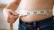 © Kukuh - Child measuring waist size with tape for health check