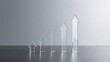 © Studicon - Five clear glass arrows pointing upwards in increasing size on a reflective surface