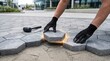 © CuteBee - Construction worker laying concrete hexagonal pavers with glowing light edges illustrating precision installation techniques for modern urban landscaping and architectural hardscape design projects