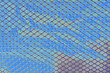 © Sevil - Abstract background of metallic diamond mesh grid pattern over iridescence holographic blue foil surface.