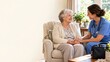 © olegganko - Home Care Nurse Holding the Hands of an Older Woman in a Sunlit Living Room