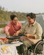 © Ryzhkov - Family preparing breakfast with a skillet and portable stove at a lakeside campground, cozy autumn morning for outdoor travel and inclusive leisure