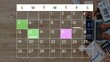 © InfiniteFlow - Colorful Monthly Calendar with Handwritten Notes and Hands Working on Laptops and Notebooks on a Wooden Surface. Entropy.