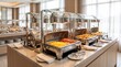 © Bro - Hotel breakfast buffet counter with hot food in metal chafing dishes in a bright modern dining room