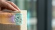 © KohXD - Person holding compressed wool insulation sample with clean cut edge and refined felted texture for natural insulation