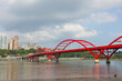 © leungchopan - Red arch bridge over river with city view in taiwan tamsui