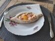 © Otar - Adjarian khachapuri with eggs and shrimp on the yellow plate. Traditional georgian pastry - adjarian khachapuri with cheese and raw yolk. Shrimp and khachapuri—an unusual combination.