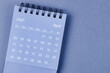 © gamjai - April 2027 Monthly desk calendar for 2026 year on blue background.
