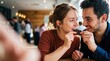 © iravgustin - A romantic Valentine's Day celebration. A smiling couple shares a delicious piece of chocolate while making eye contact.