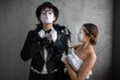 © Nomad_Soul - Mime couple posing elegantly against a white studio wall