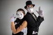 © Nomad_Soul - Mime couple standing back to back making hand gun signs