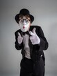 © Nomad_Soul - Male mime leaning forward waving with a big white gloved hand