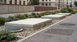 © Satriyo - Modern urban landscaping featuring robust concrete elements and diverse low-maintenance plants along a city sidewalk, enhancing the street aesthetic and urban functionality
