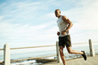 © peopleimages.com - Athlete, black man and running for training on promenade for fitness, cardio exercise and endurance. Male person, space and runner jogging for sports workout, marathon practice and pace for wellness