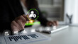 © InfiniteFlow - A business professional interacts with a digital payroll interface while reviewing financial documents, showcasing modern technology in a professional workspace setting. Cyphers