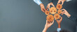 © InfiniteFlow - A diverse group of hands hold wooden gears featuring icons that symbolize teamwork and collaboration, illustrating the importance of uniting ideas in a workshop setting. Amity