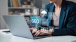 © Forida - Business professional using a laptop with floating digital icons for online technology concepts