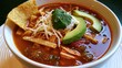 © The Little Hut - Delicious bowl of authentic Mexican chicken tortilla soup with avocado, cilantro, and crispy tortilla strips