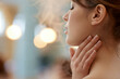 © S.Jirut - Female fingertips performing a gentle spa massage on the side of a woman neck with széchenyi thermal bath architecture behind