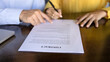 © fizkes - Close up of female client signing contract, buying company services, take bank loan sit at desk with male manager or advisor, finish negotiations successfully, closing business deal, start partnership