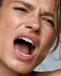 © lashkhidzetim - Close-up of a woman screaming. Her eyes are tightly shut. Teeth are fully exposed. Skin shows natural texture and imperfections. Emotion is raw and powerful. Ideal for dramatic, intense