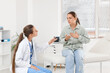 © Pixel-Shot - Medical consultation and patient care, doctor talking to a worried woman about health symptoms and diagnosis in a clinic office with professional support