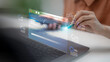 © FAMILY STOCK - A software developer using a laptop and touching a virtual screen for software update progress, system maintenance installation, operating system upgrade, and modern digital data processing.