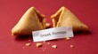 © Shibly Sadik - Broken fortune cookie with a paper slip reading great success on a plain dark red background for a lucky message