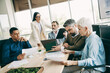 © deagreez - Diverse professionals collaborating in an office meeting with teamwork showcasing corporate planning and mutual cooperation