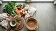 © XTFK - Fresh organic vegetables and herbs arranged on a stone surface with cloth bags