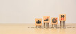 © Achmad Khoeron - Wooden blocks on stacked coins showing business team, growth chart, target goal, and the year 2027. Representing financial growth planning, investment strategy, economic forecast, long term business.