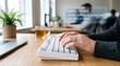 © Myoui - Professional hands typing on white keyboard with futuristic artificial intelligence text prediction overlay for corporate project management