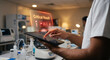 © Akash Tholiya - Clinician hand on tablet with critical lab result alert hologram, red flagged value and warning icon, medical laboratory notification and patient safety technology concept