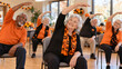 © AnyPic289 - Older Adults Do Seated Stretches at Halloween Gathering